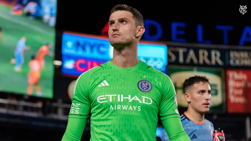 NYCFC goalkeeper Matt Freese wearing a green Etihad Airways jersey during a match.