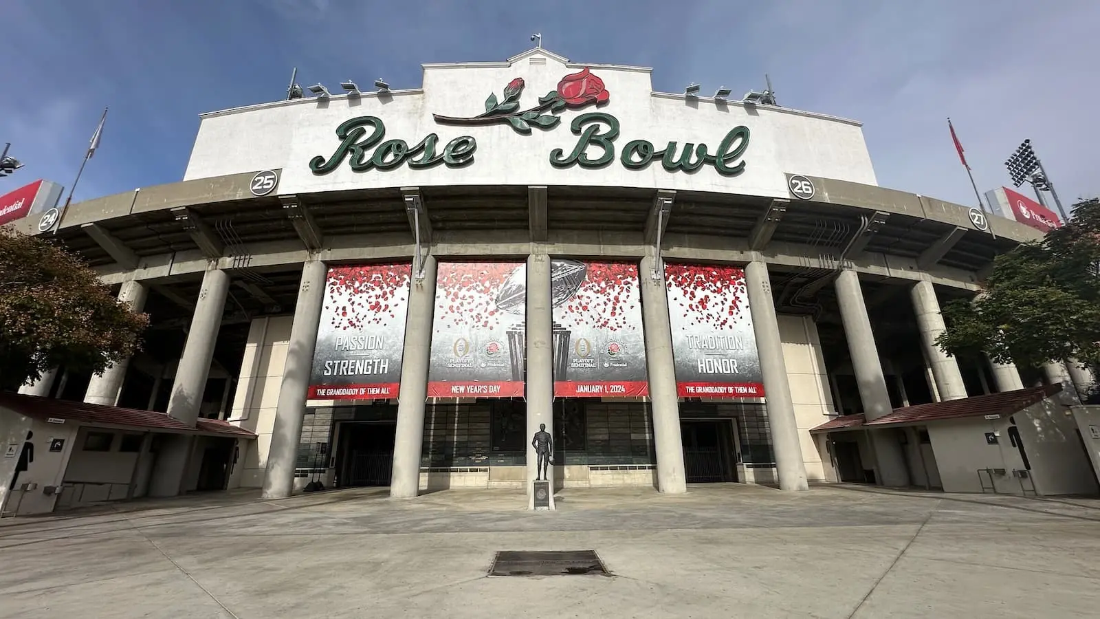 Exterior view of the Rose Bowl stadium in Pasadena with banners and sign.
